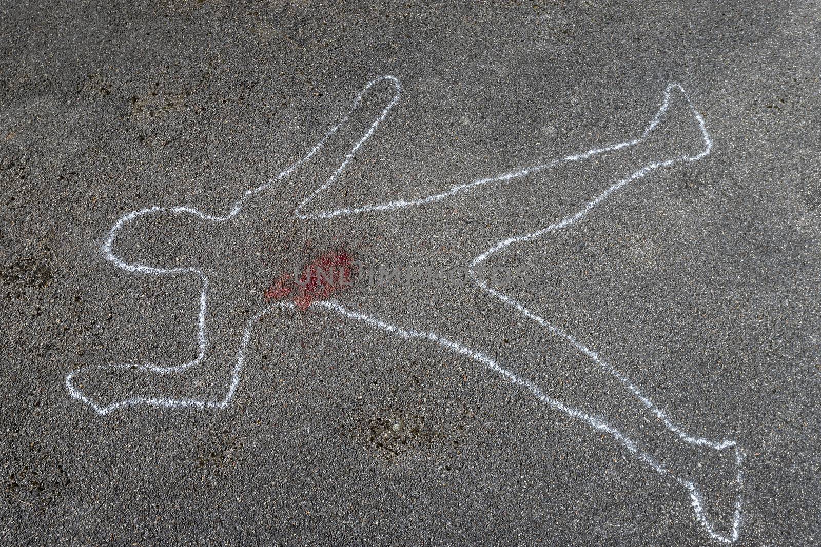 outline of a body on asphalt