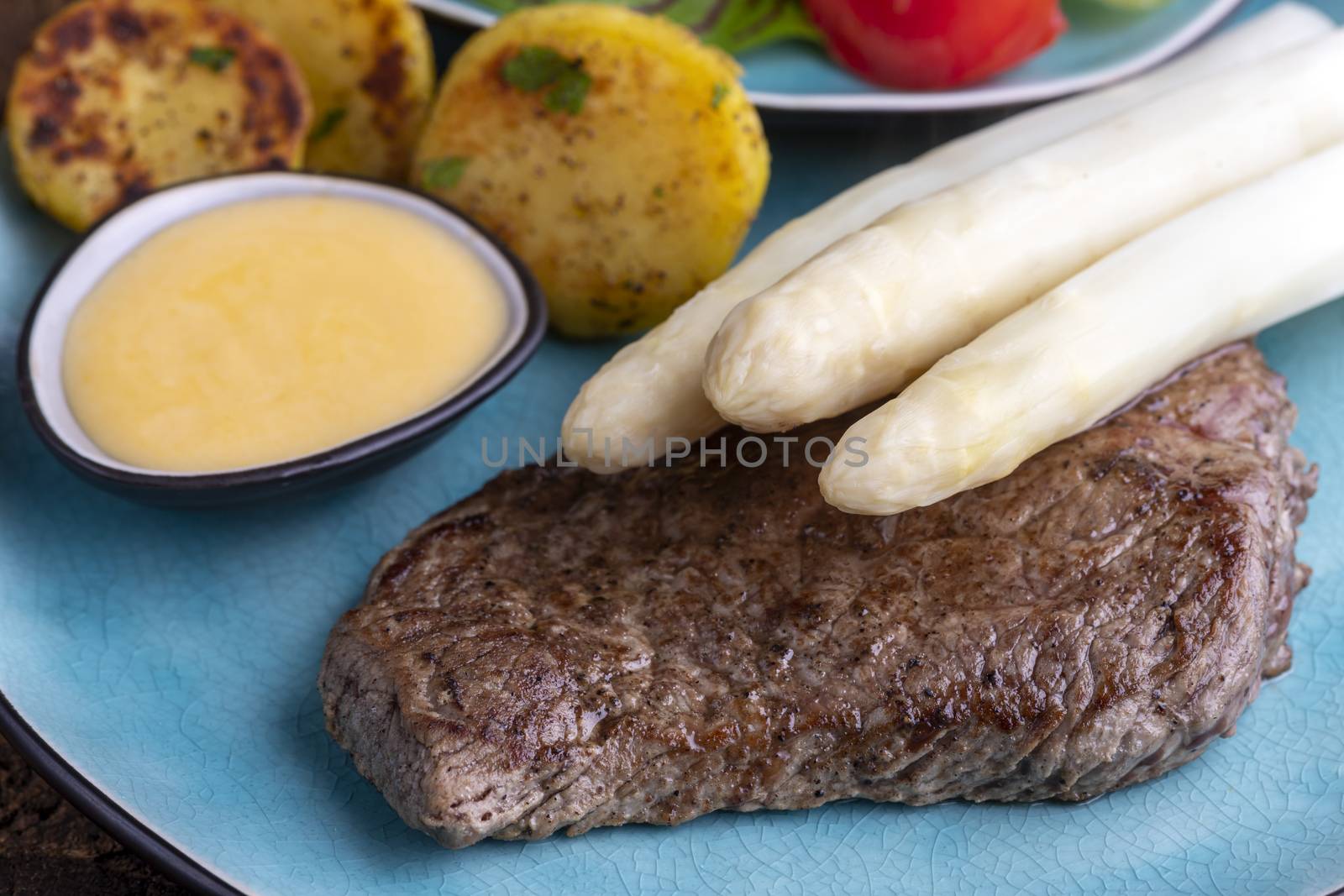 white asparagus on a grilled steak