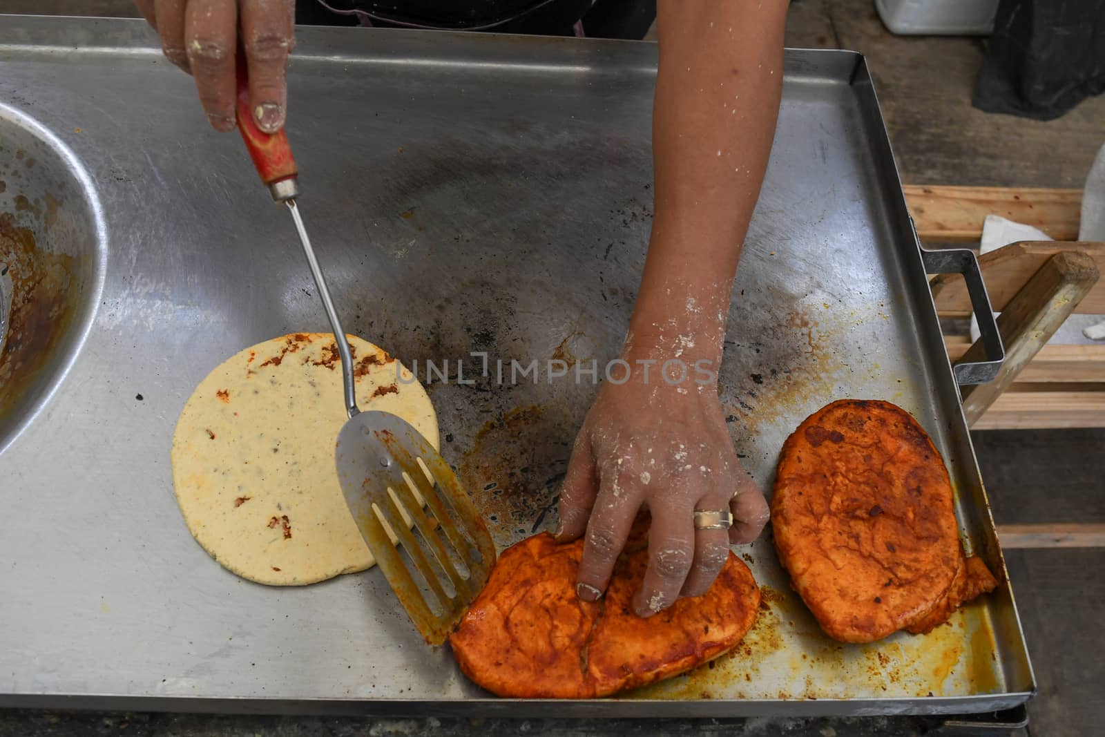 Photo of two hands preparing a typical mexican dishes