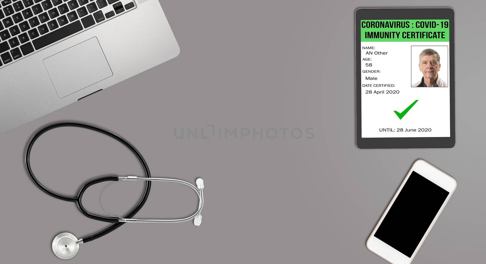 Clean and tidy grey desk with equipment ready for medical doctor showing his coronavirus immunity certificate on app