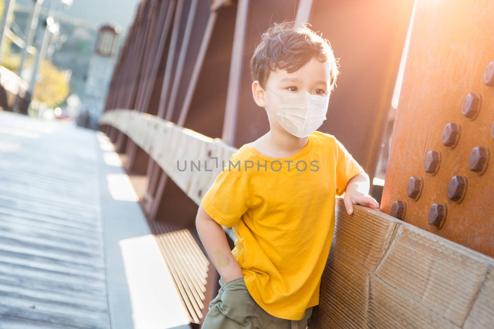Young Mixed Race Chinese and Caucasian Boy Playing Alone Wearing Medical Face Mask Outside. by Feverpitched
