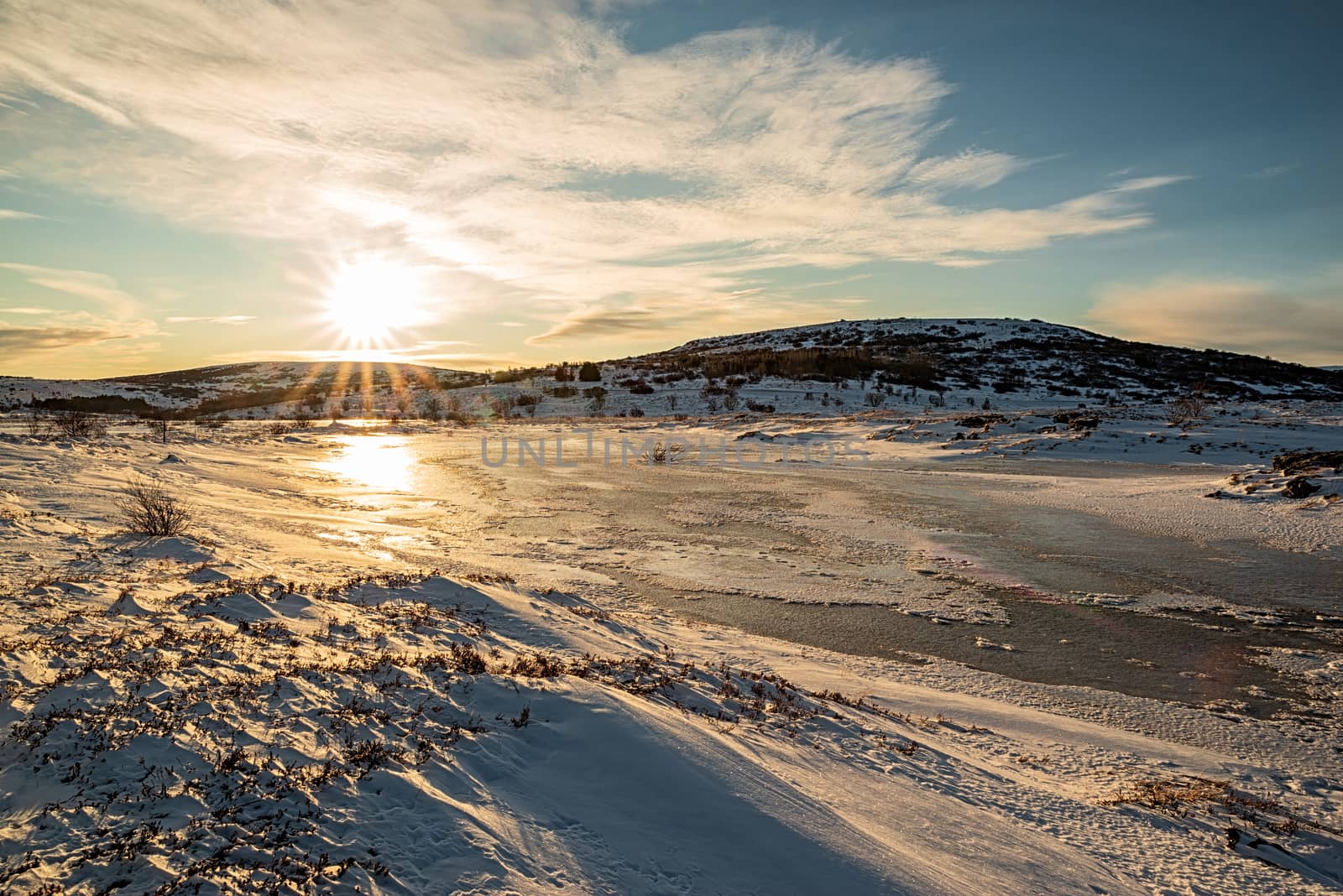 Iced lake in Vifilstadir area in Gardabaer at sunrise, Iceland