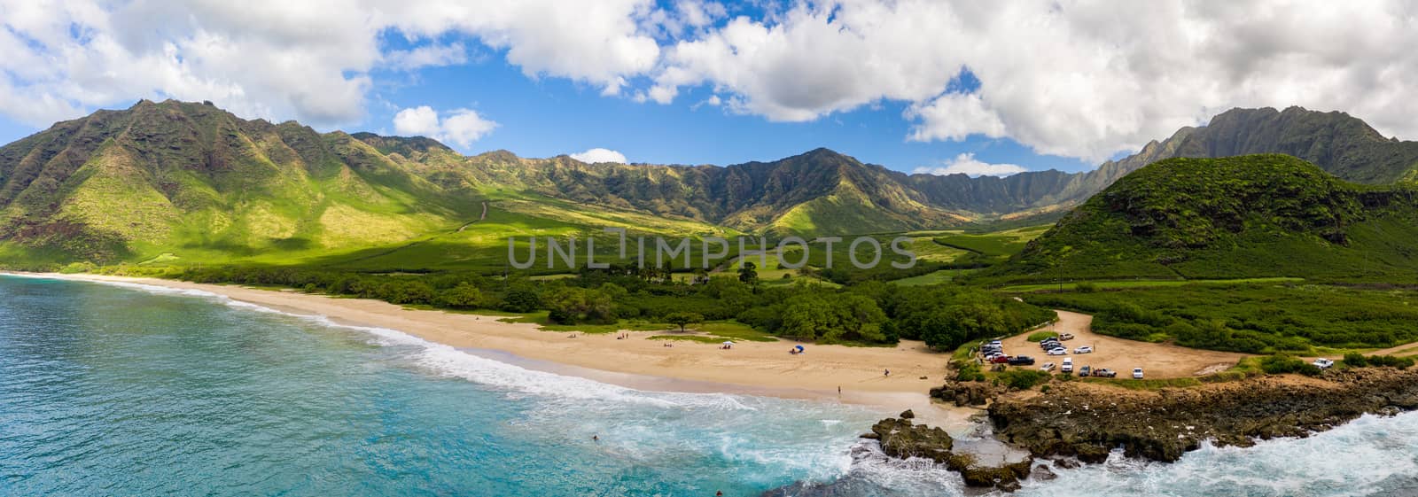 Makua beach and valley on west coast of Oahu in aerial shot over ocean by steheap