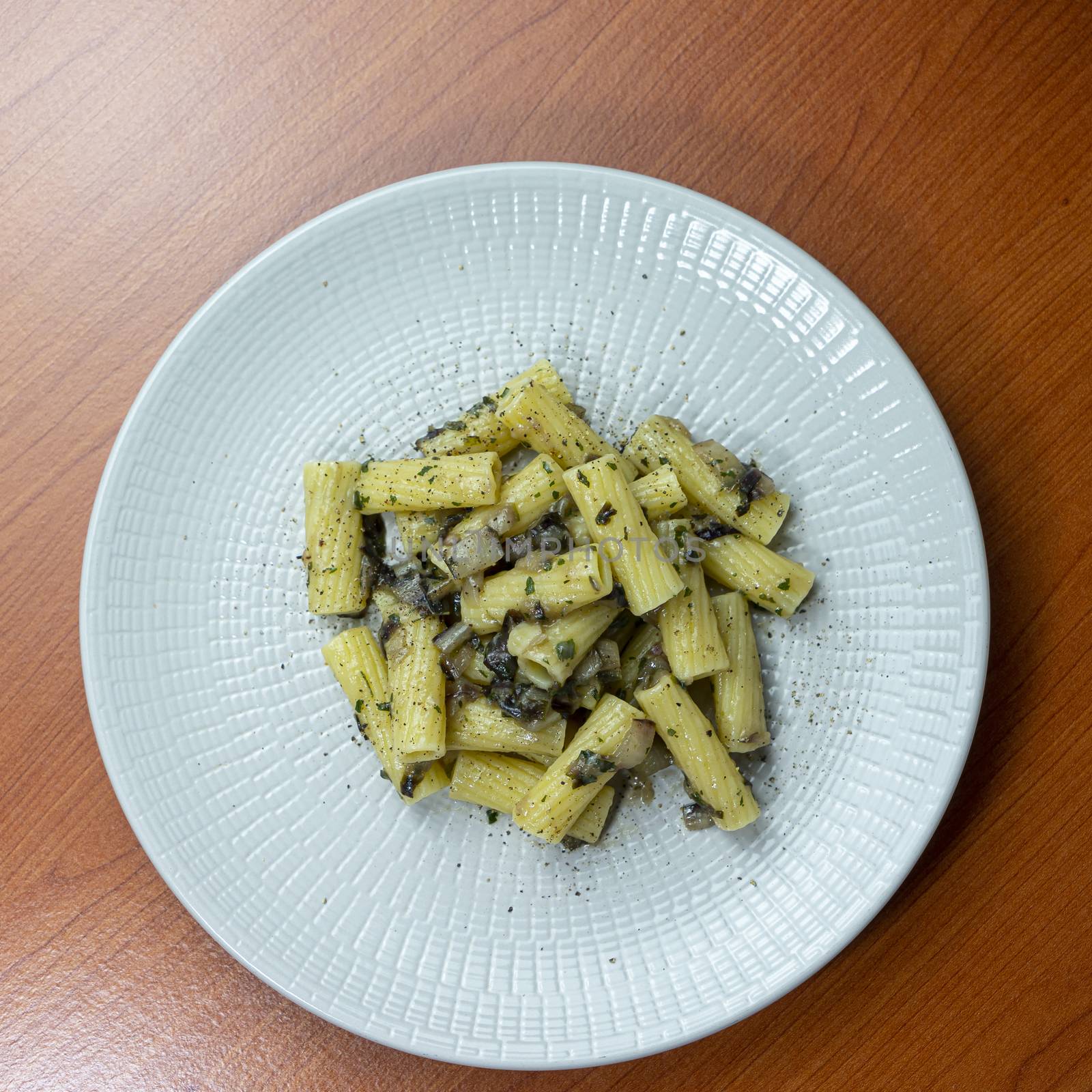 A dish of rigatoni with late red radicchio sauce