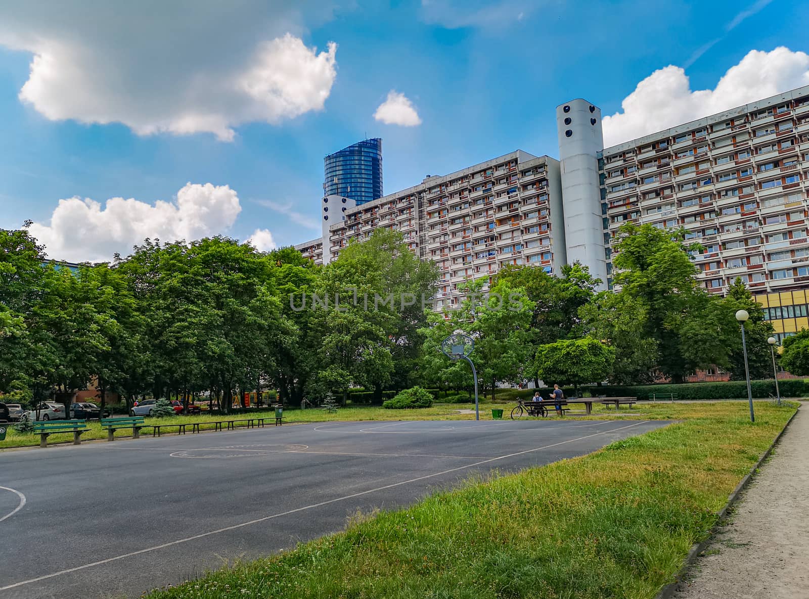 Residential buildings and apartments with colorful park and playgrounds in front of at sunny day in Wroclaw city