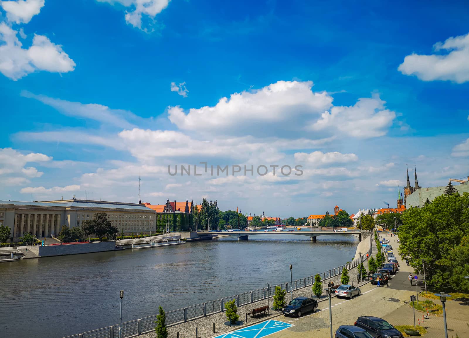 Wroclaw cityscape with river, bridge and cloudy sunny day by Wierzchu