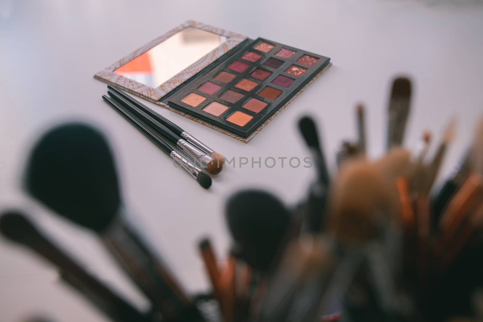 Makeup cosmetics tools background & beauty cosmetics, products & facial cosmetics package lipstick, eyeliner, concealer, mascara, eye shadow stick & highlighter palette on white color background.