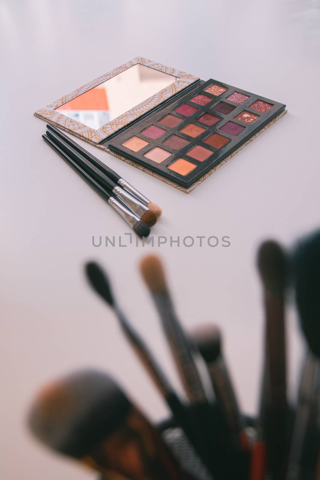 Makeup cosmetics tools background & beauty cosmetics, products & facial cosmetics package lipstick, eyeliner, concealer, mascara, eye shadow stick & highlighter palette on white color background.