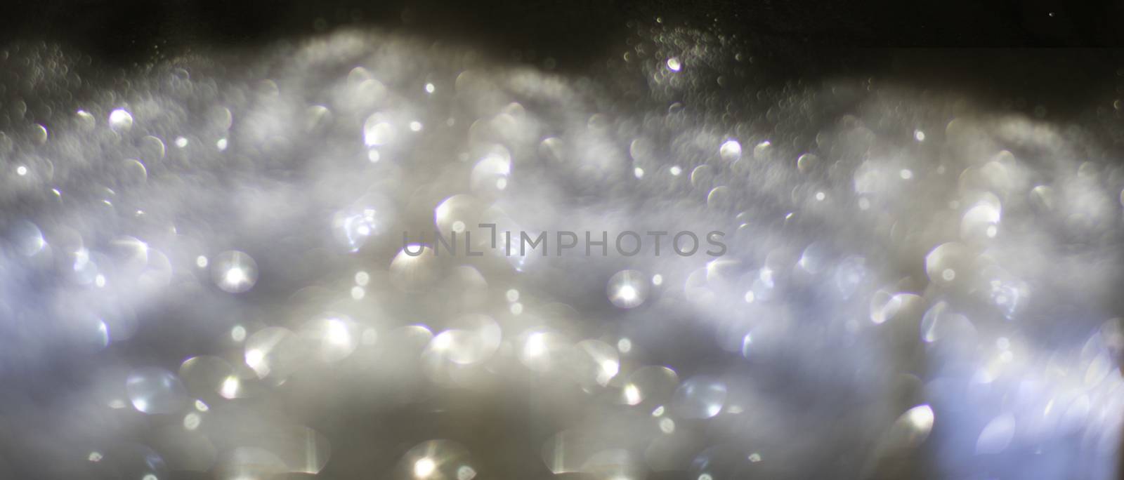 abstract background composed ofsilver bokeh