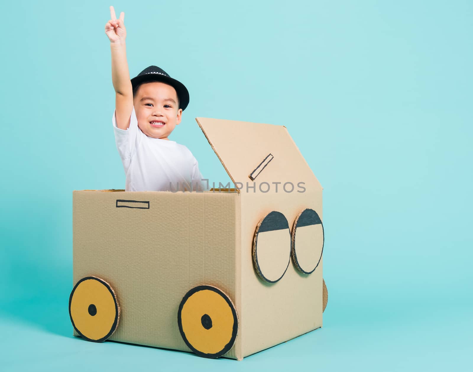 Baby children boy smile in driving play car creative by a cardbo by Sorapop