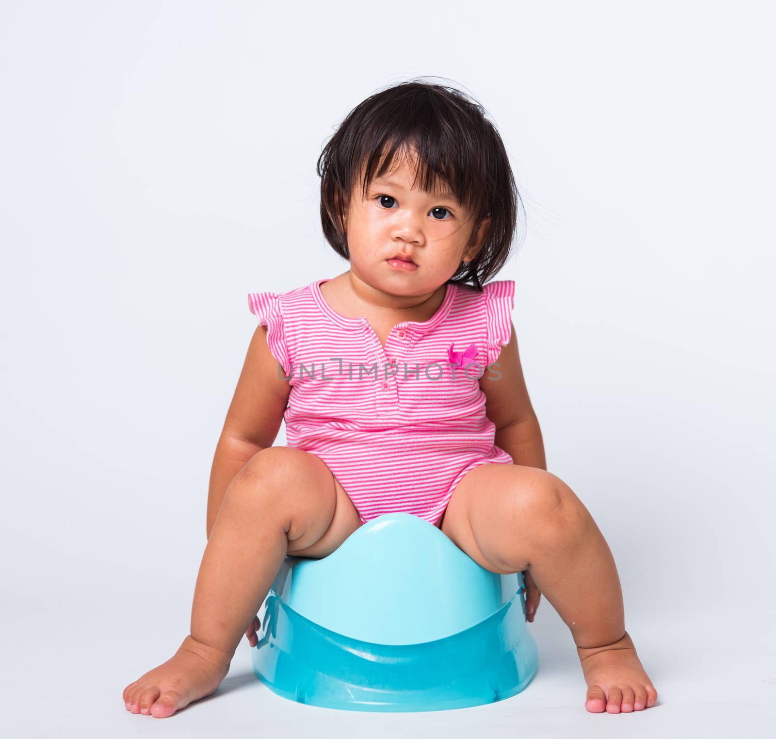 Asian little cute baby child girl education training to sitting on blue chamber pot or potty in, studio shot isolated on white background, wc toilet concept
