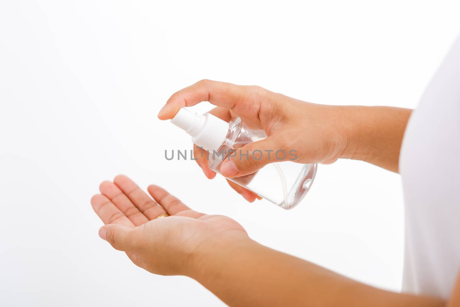 Closeup Hand Asian young woman applying spray pump dispenser sanitizer alcohol on hand wash cleaning, hygiene prevention COVID-19 or coronavirus protection concept, isolated on white background