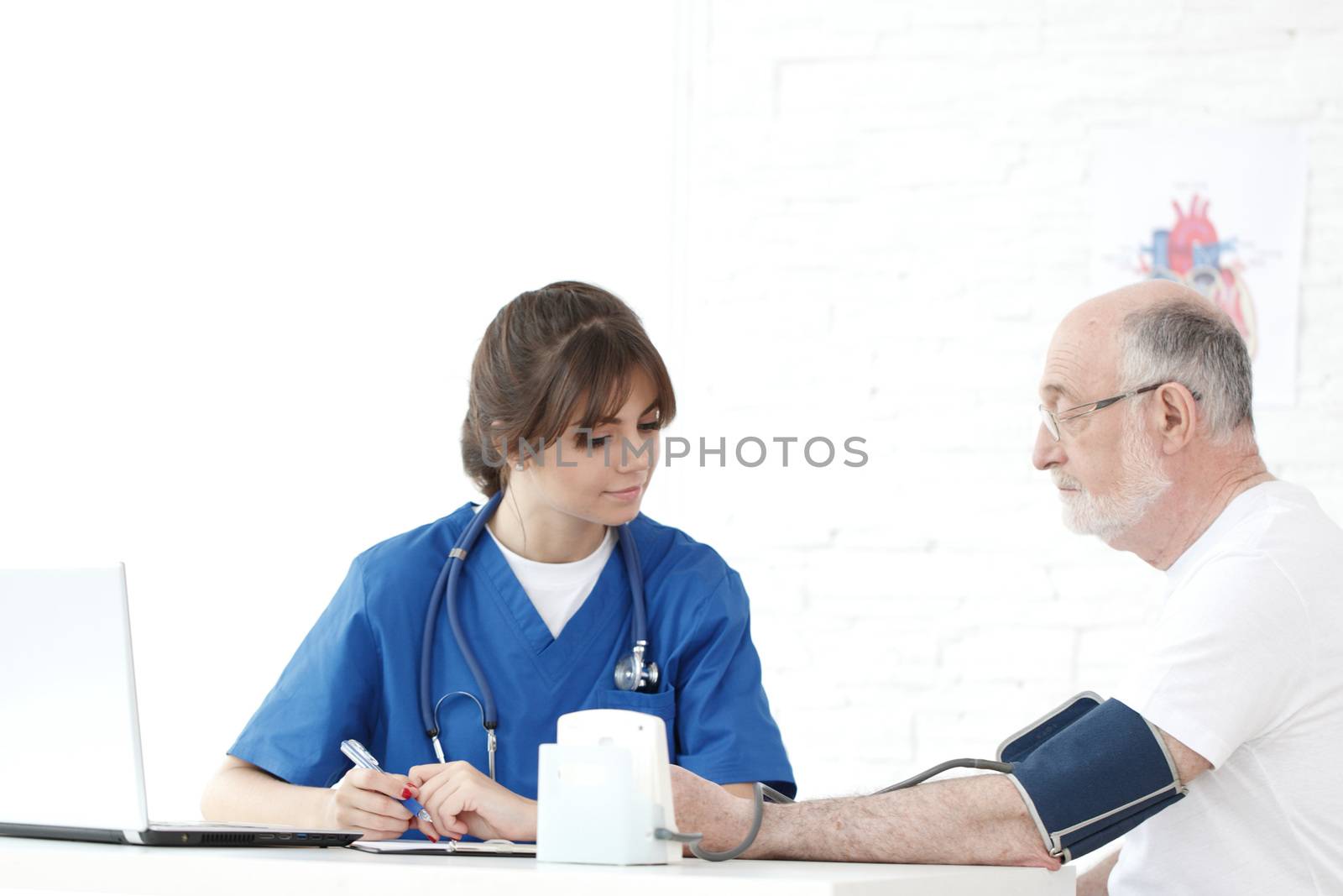 Doctor measuring blood pressure of male senior patient cardiology heart care concept
