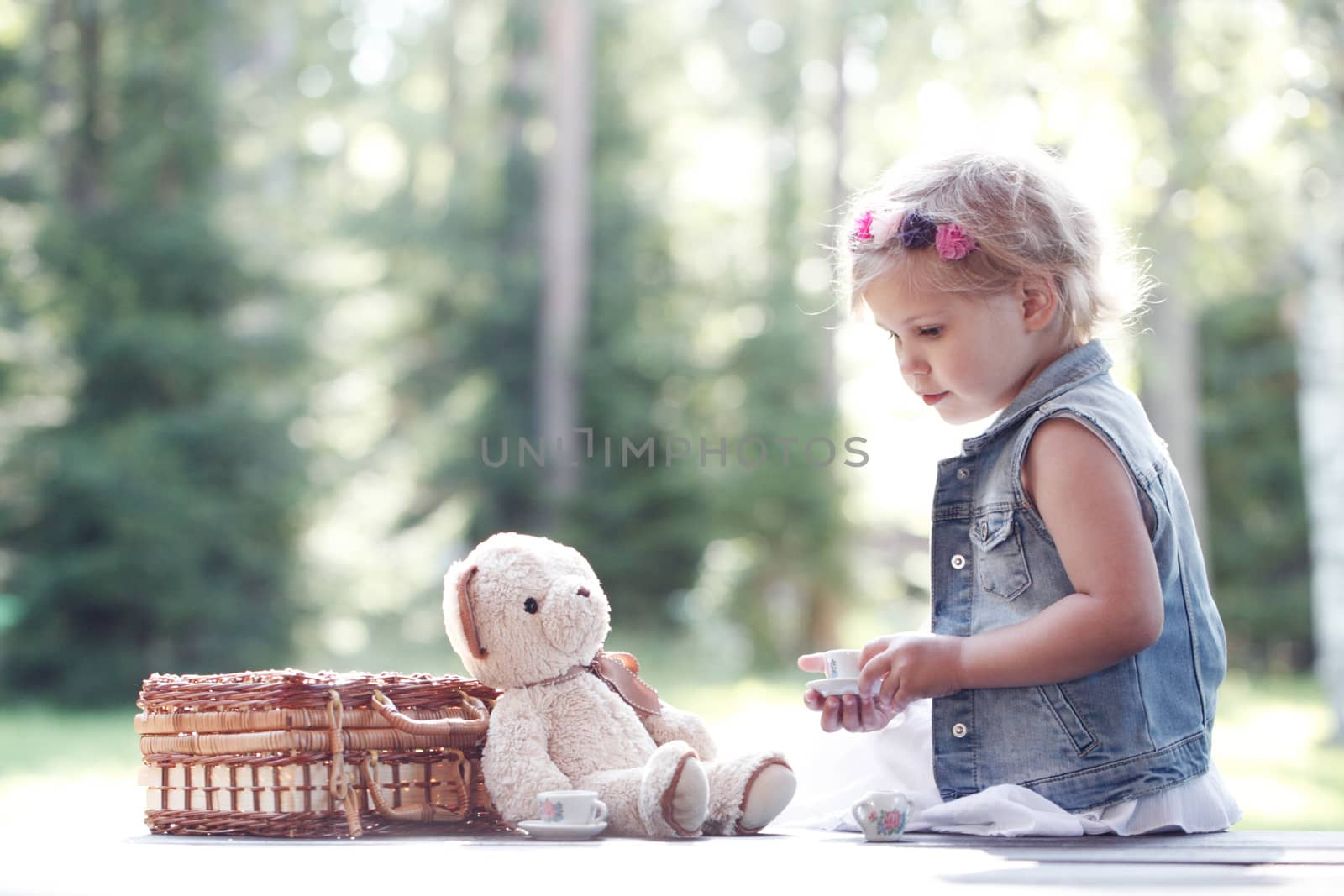 Girl playing with teddy bear by ALotOfPeople