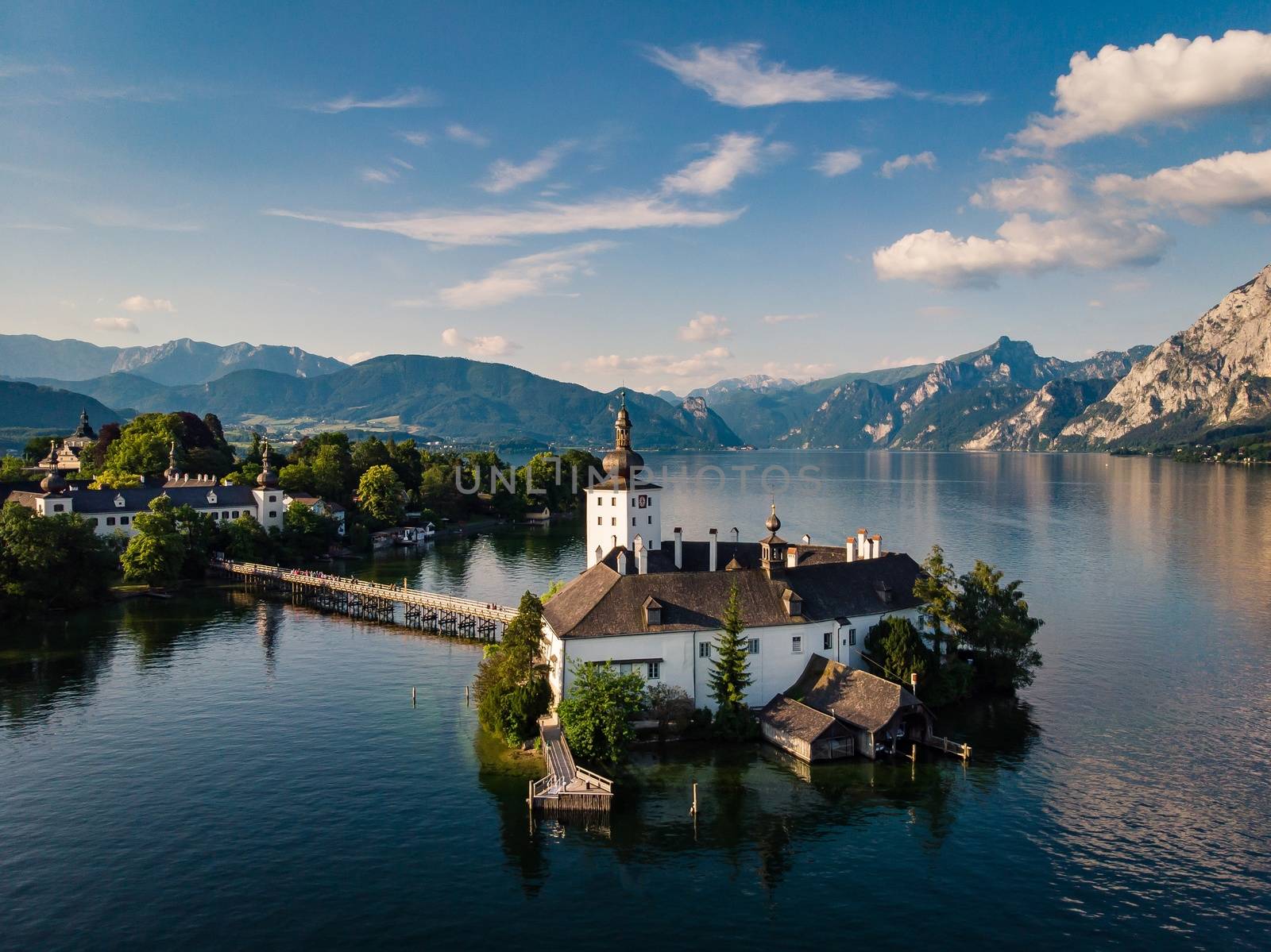 Classic postcard view of famous Hallstatt lakeside town with traditional ship in beautiful morning light at sunrise in summer.