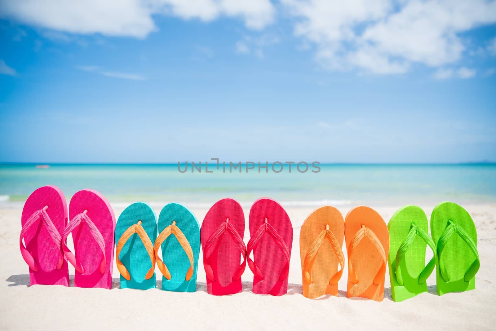 Colorful flip flops on the sandy beach in Hawaii, Kauai by bhavik_jagani