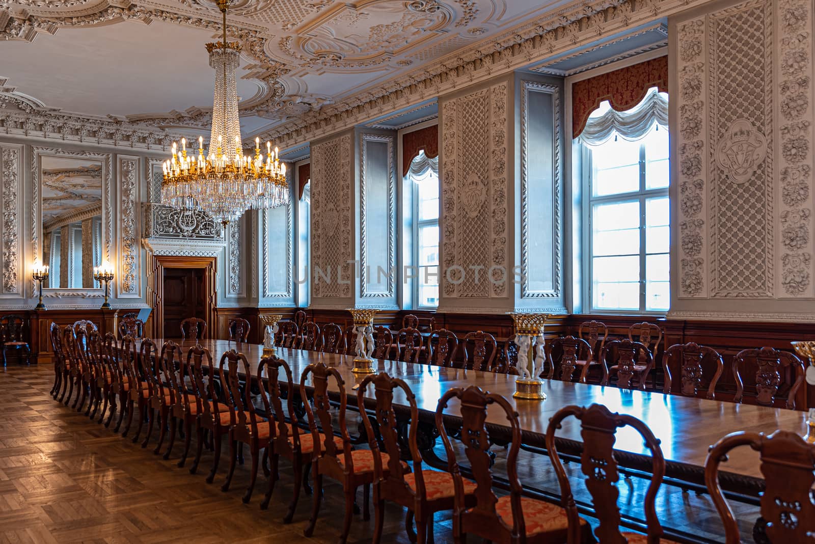 Interiors of the royal halls in the Christiansborg Palace in Copenhagen, Denmark, large antique table and crystal chandelier