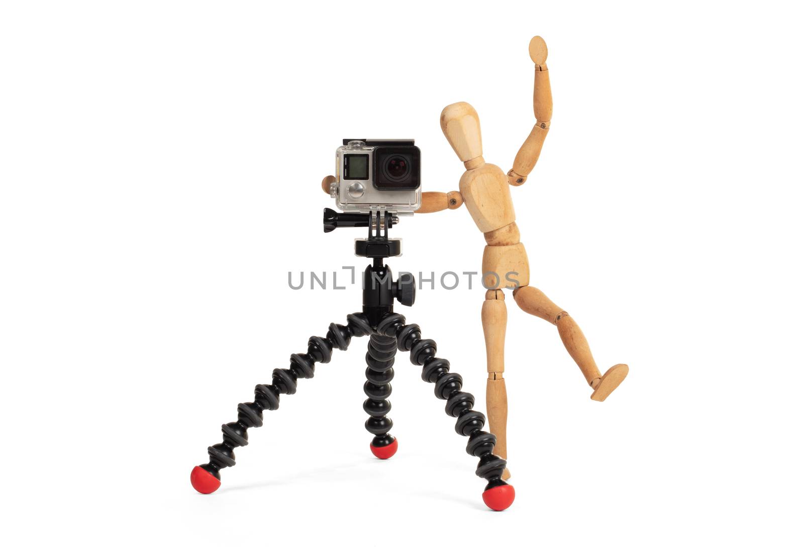 Wooden dummy standing trying to make a video or photo, isolated on white