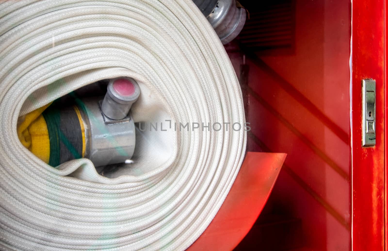 Roll of canvas hose in the emergency firefighting box