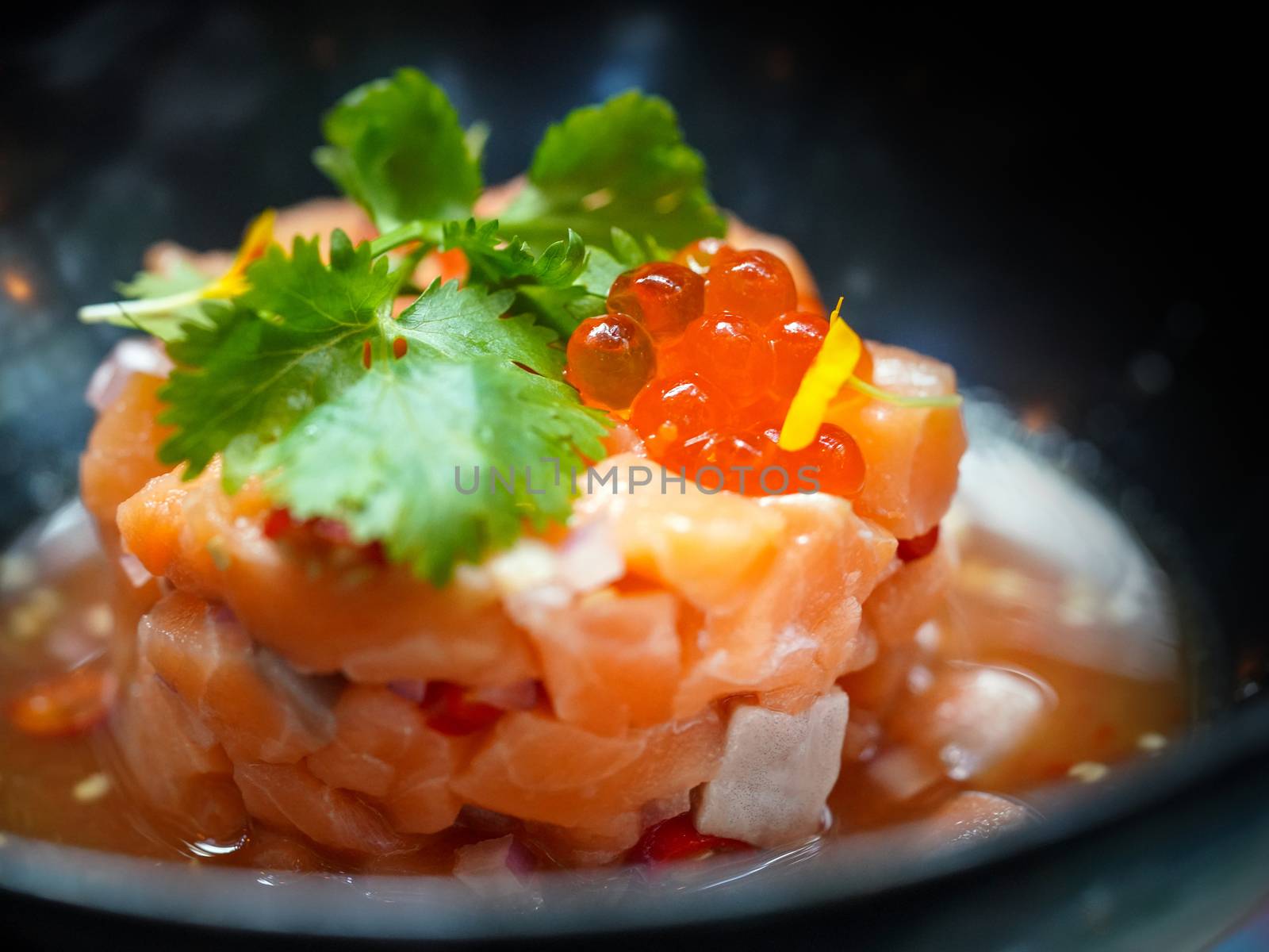 Salmon Zap with Thai Spicy Seafood Sauce served on black plate.