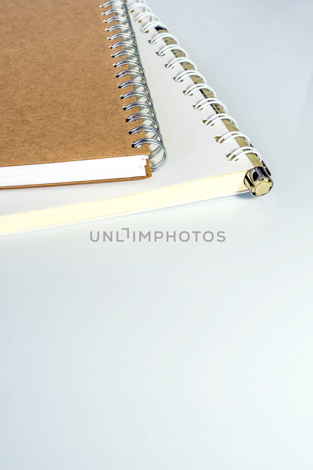 The spiral notebook with pen by Satakorn