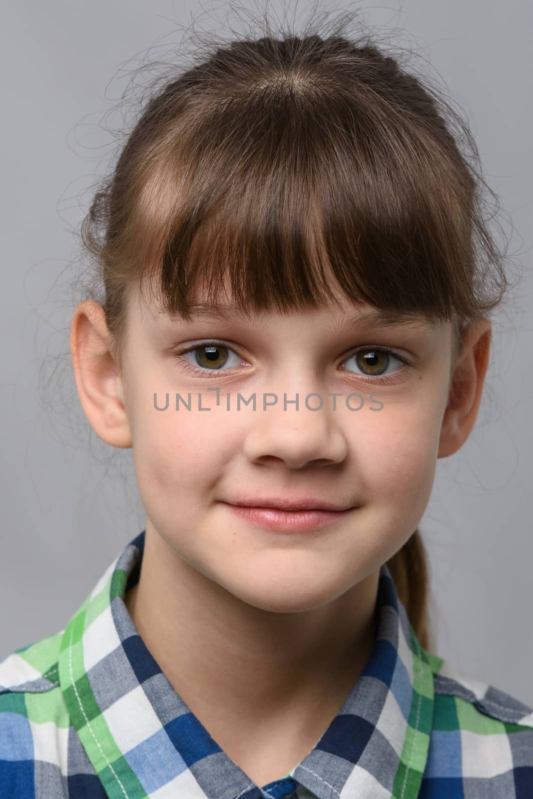 Portrait of a happy ten year old girl of European appearance, close-up