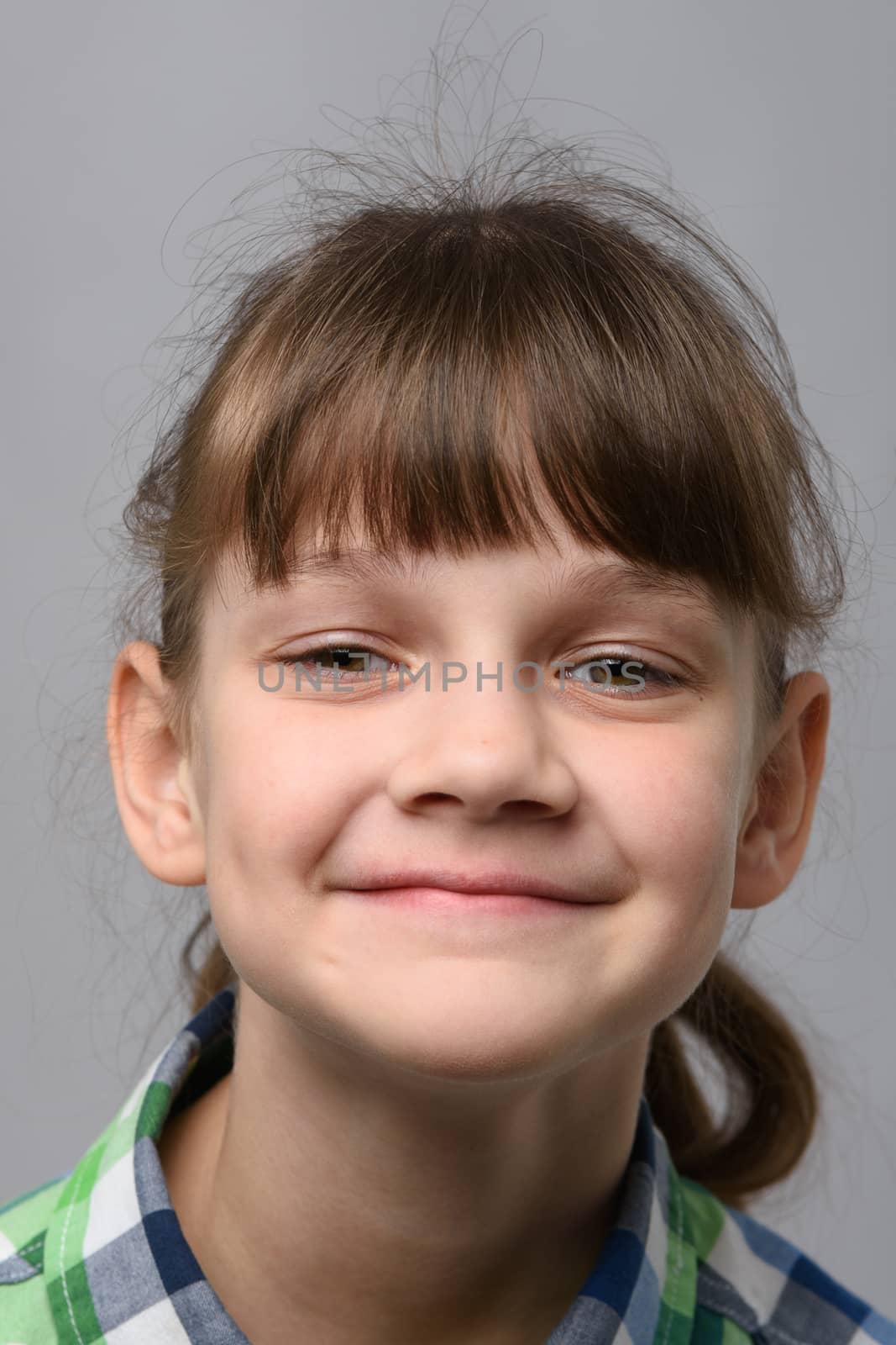 Portrait of a happy ten-year-old girl of European appearance, close-up