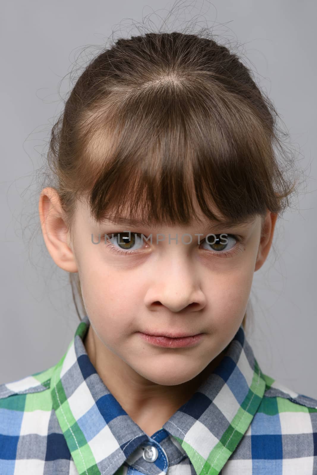 Portrait of a nervous ten-year-old girl of European appearance, close-up