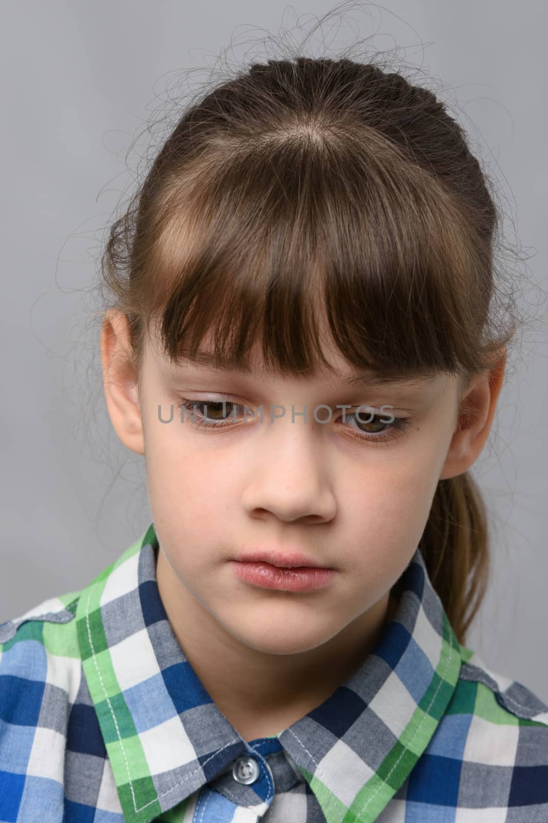 Portrait of a sad ten-year-old girl of European appearance, close-up