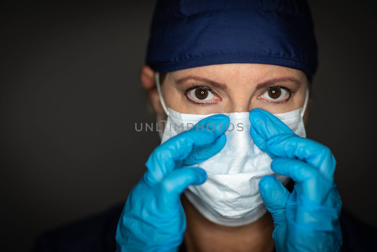 Female Doctor or Nurse Wearing Surgical Gloves Putting On Medical Face Mask.