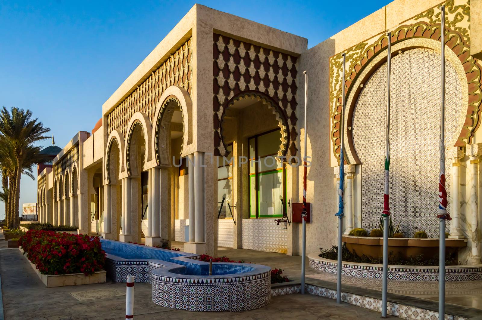 Front view of several arches with wooden railings intertwined at the arcade in Hurghada, Egypt