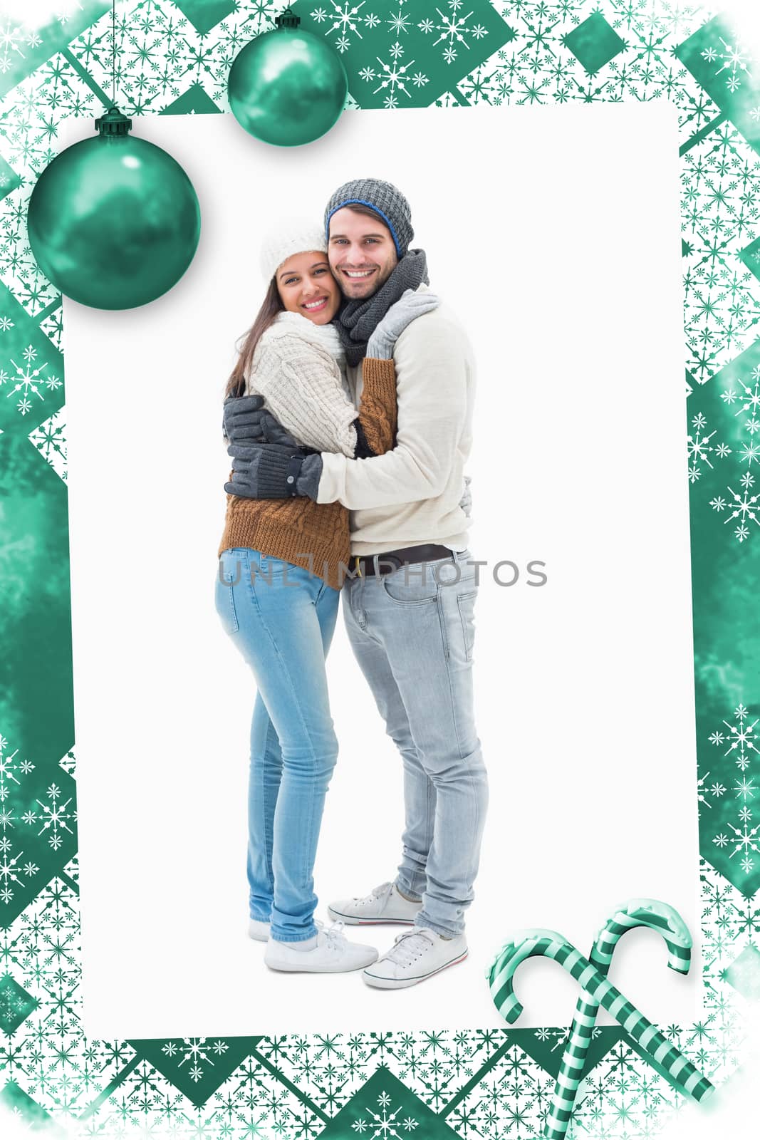 Composite image of attractive young couple in warm clothes hugging by Wavebreakmedia