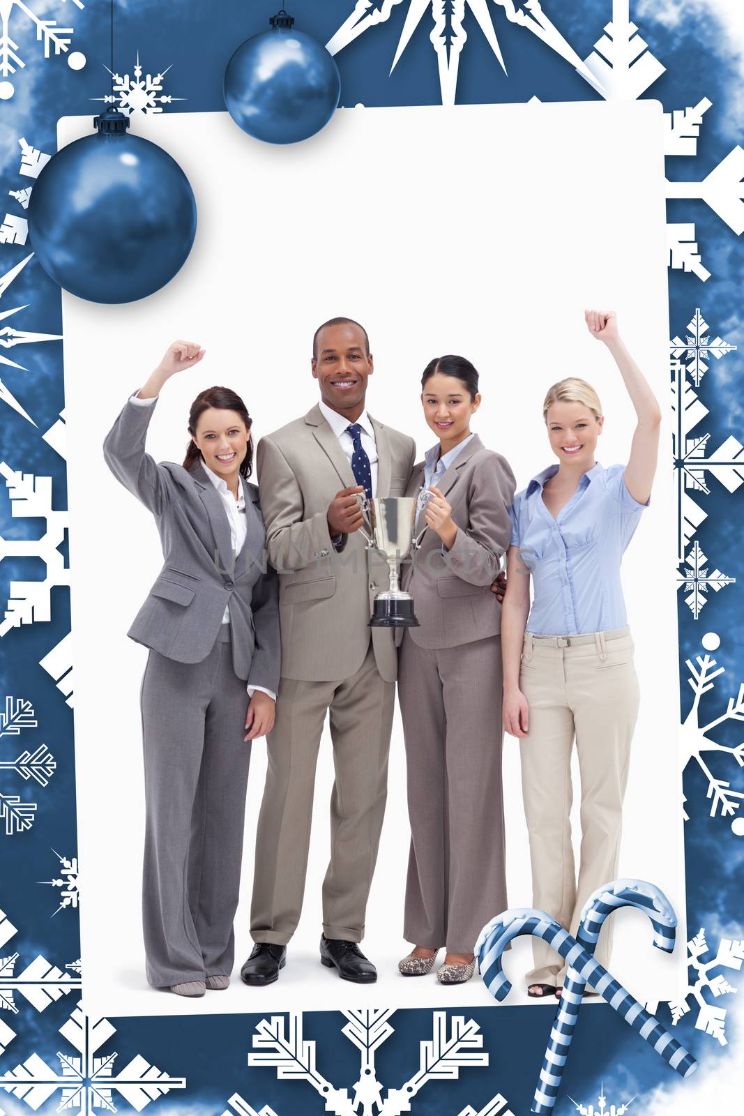 Happy business team holding a cup against christmas frame