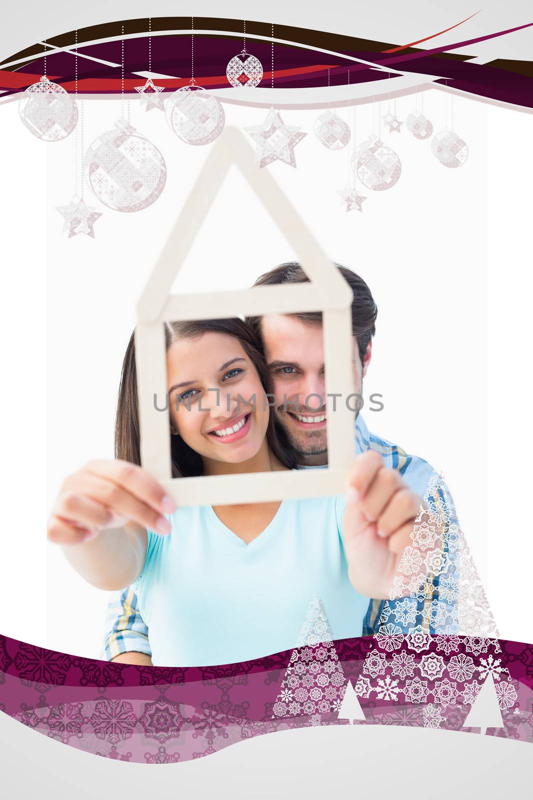 Composite image of happy young couple with house shape by Wavebreakmedia