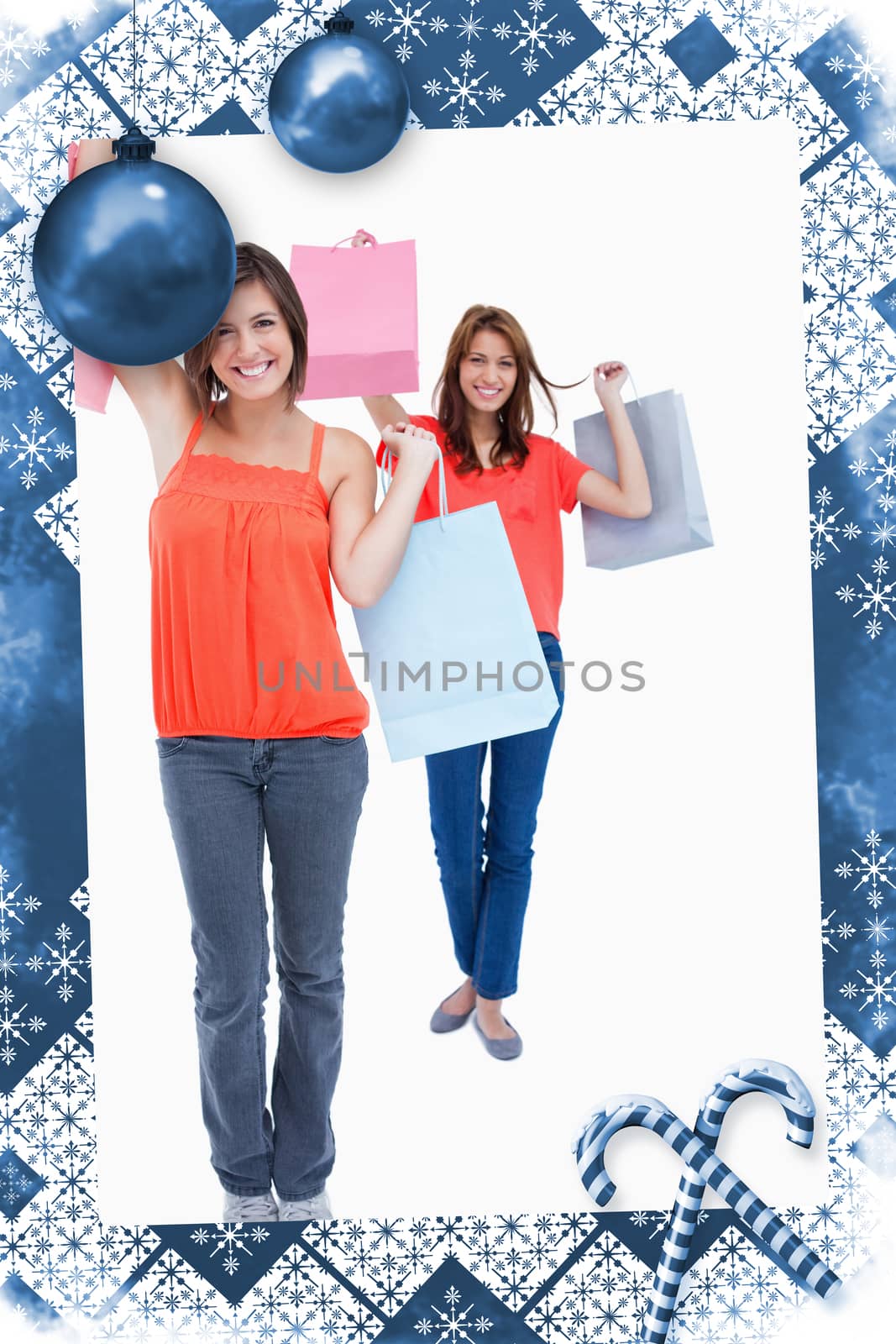 Smiling teenagers holding purchase bags in the air  by Wavebreakmedia