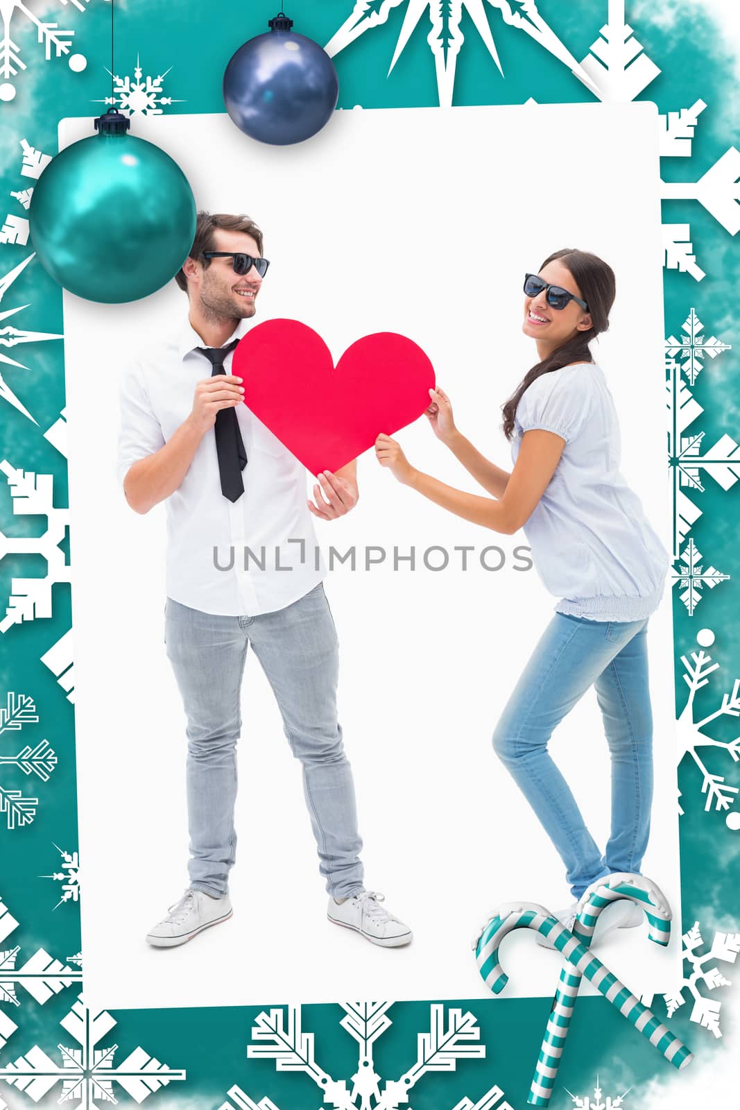 Composite image of hipster couple smiling at camera holding a heart by Wavebreakmedia