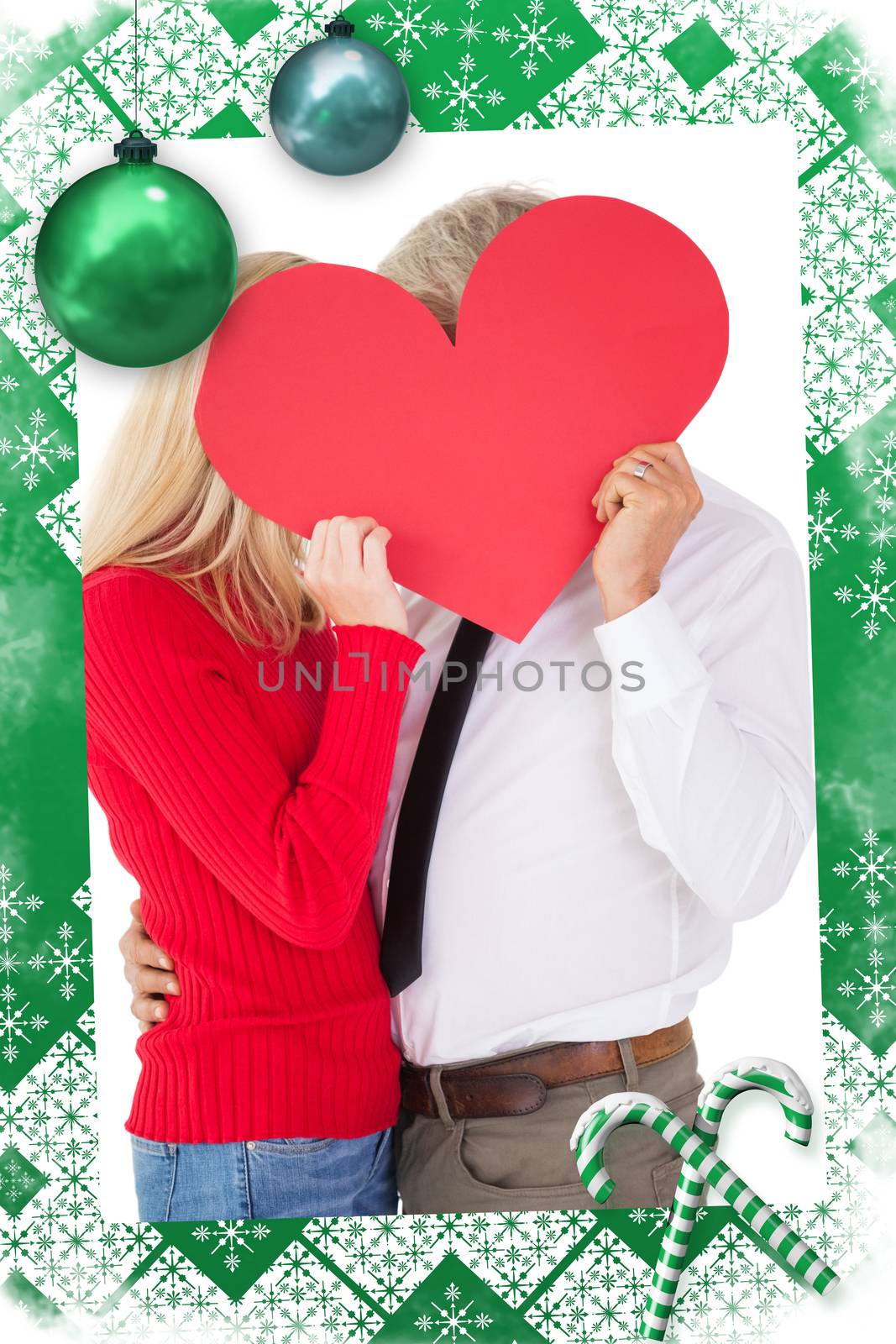 Composite image of handsome man getting a heart card form wife by Wavebreakmedia