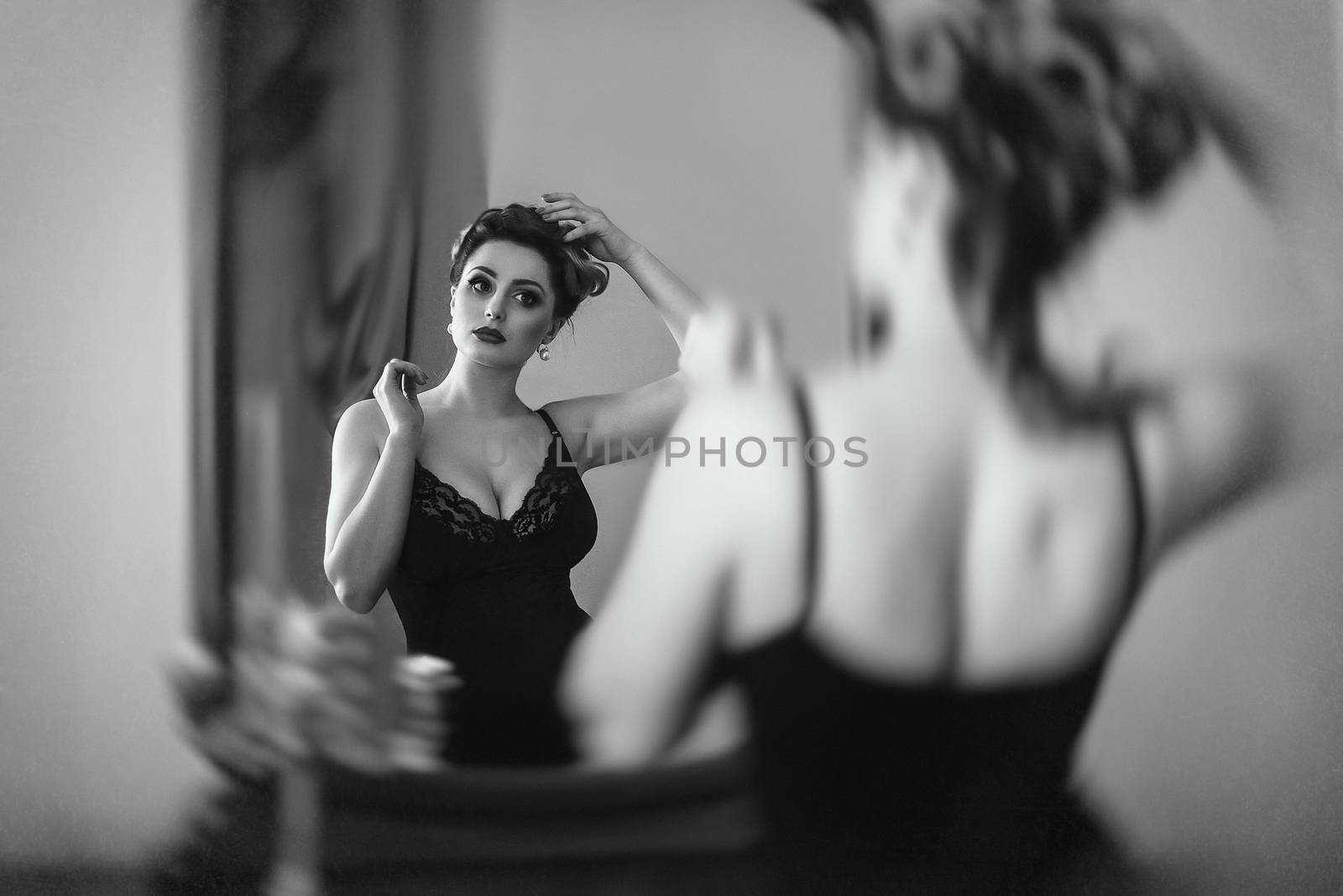 young brunette model girl and actress in front of a mirror, black and white