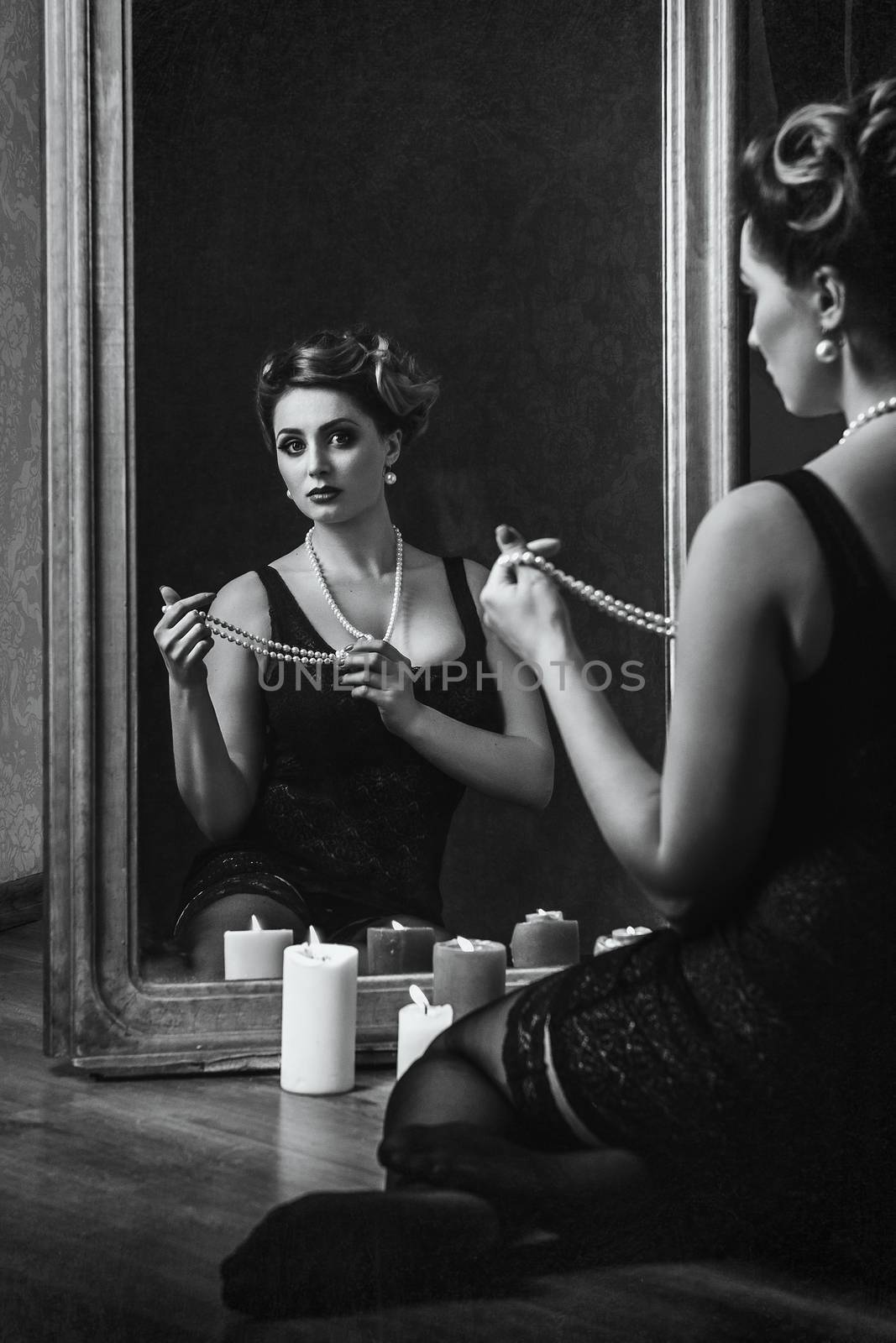 young brunette model girl and actress in front of a mirror, black and white