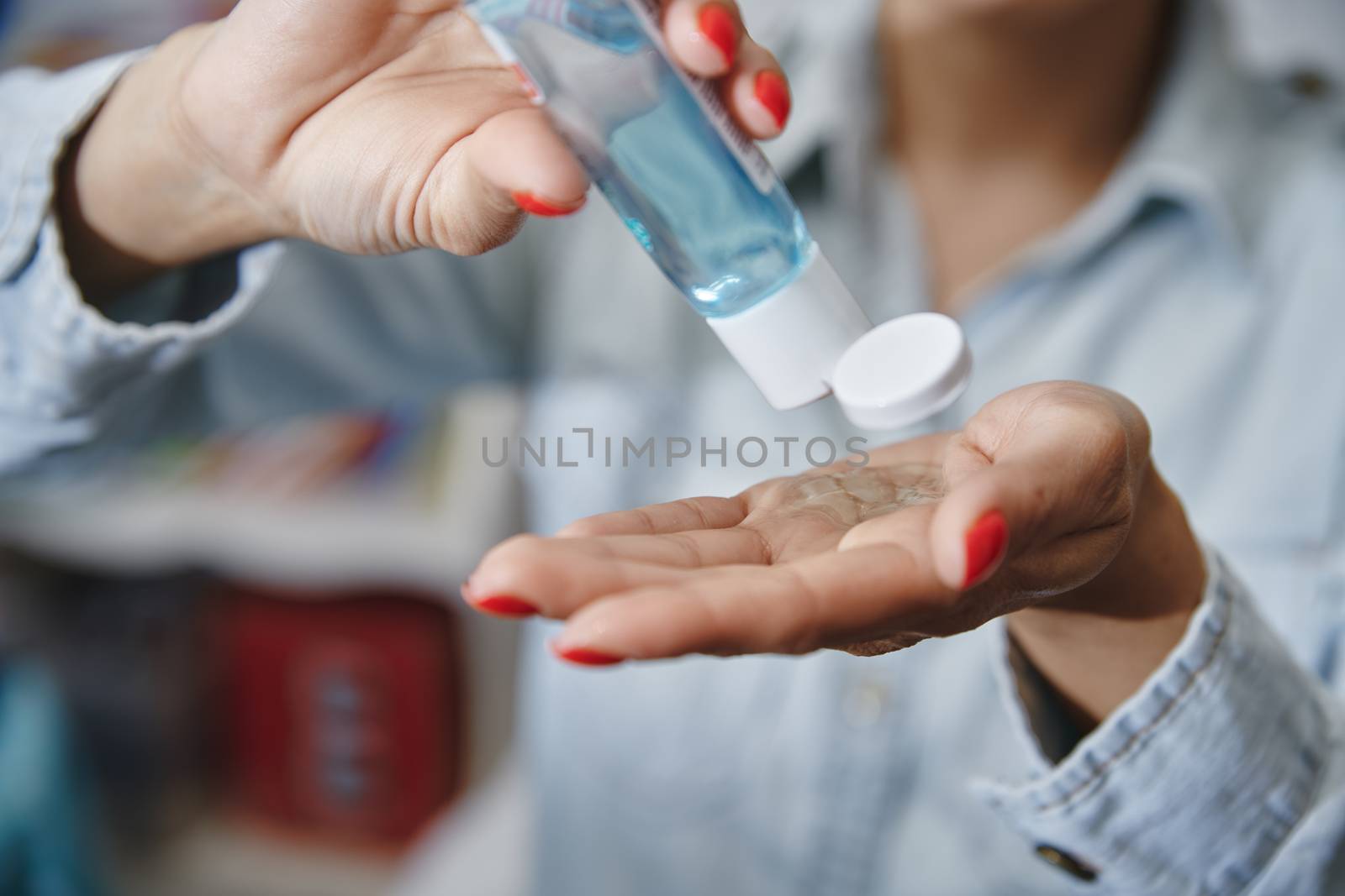 Woman using a moisturizing lotion for disinfection by Novic