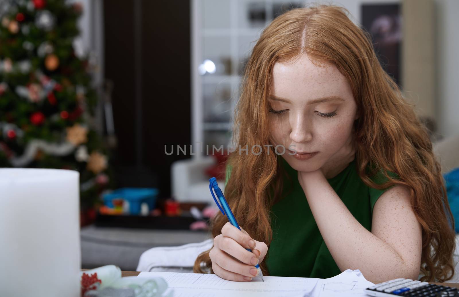 Teenage girl (13-15 years) doing homework by Novic