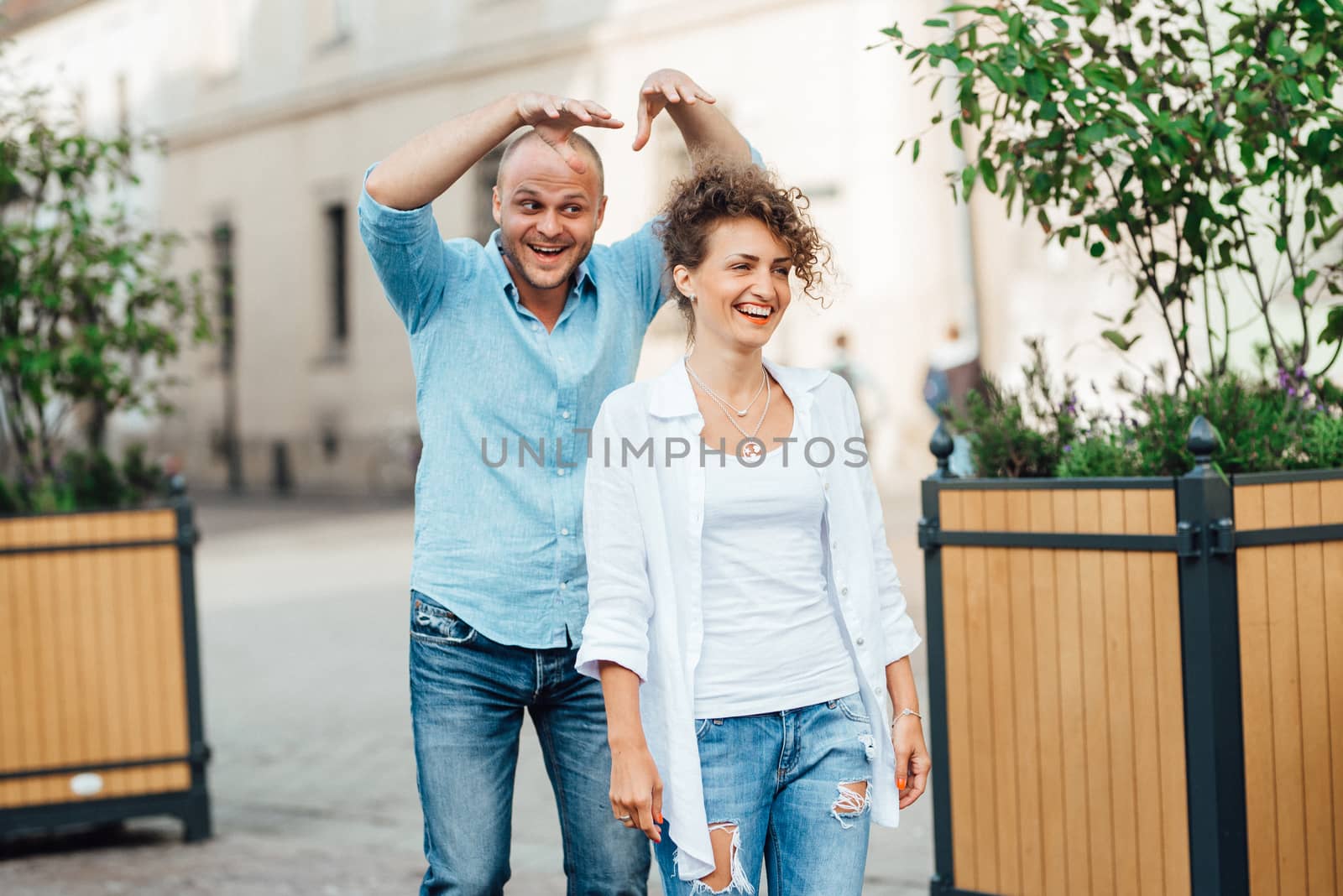 guy and a girl happily walk in the morning on the empty streets of old Europe