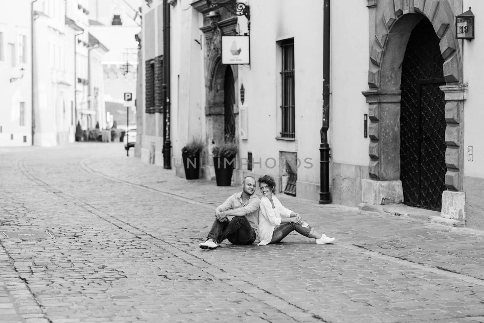 guy and a girl happily walk in the morning on the empty streets of old Europe