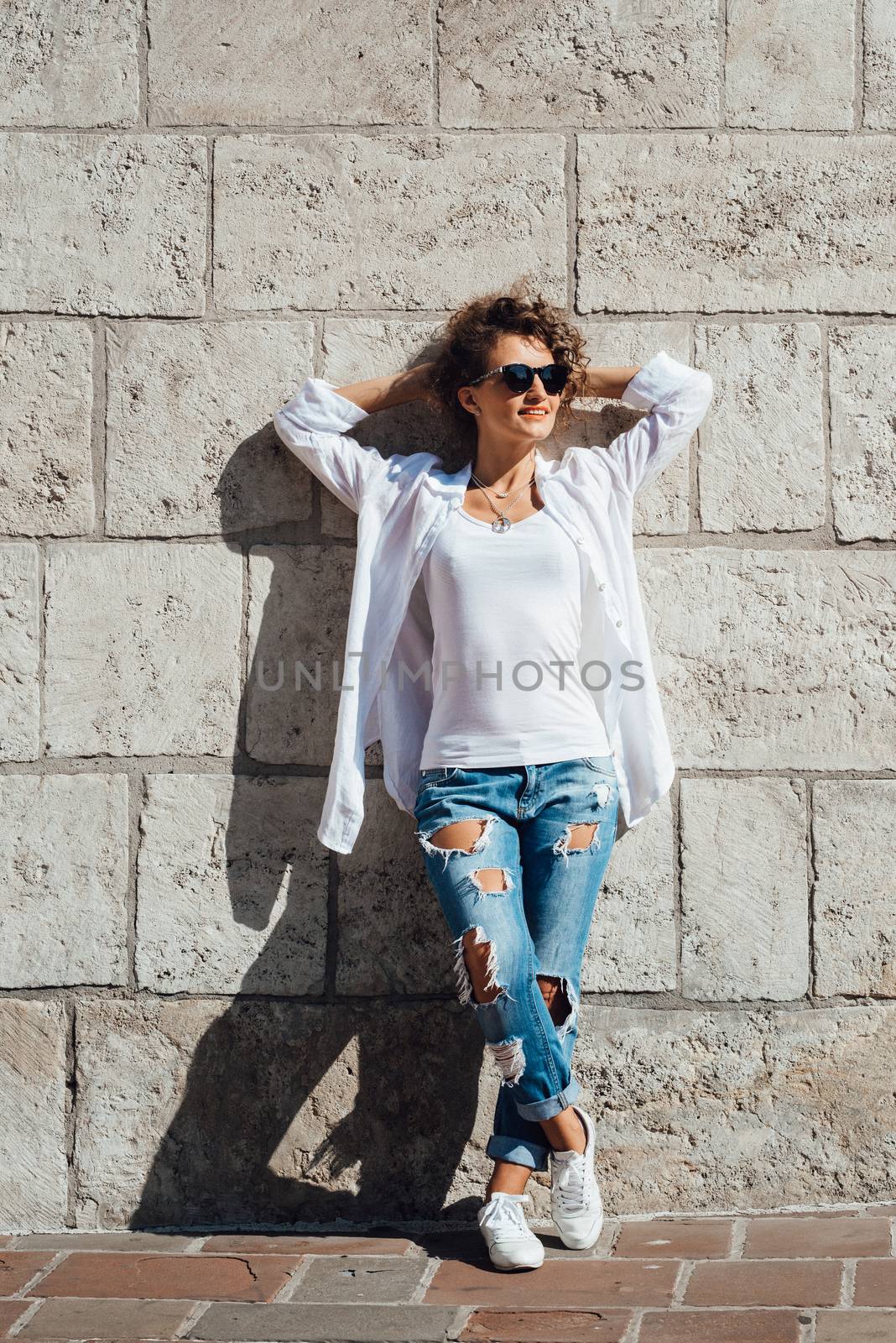 young girl walking on the old streets of europe by Andreua