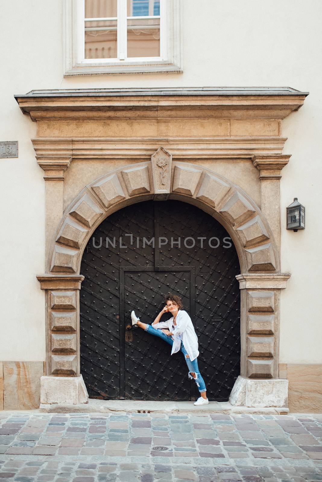 young girl walking on the old streets of europe by Andreua