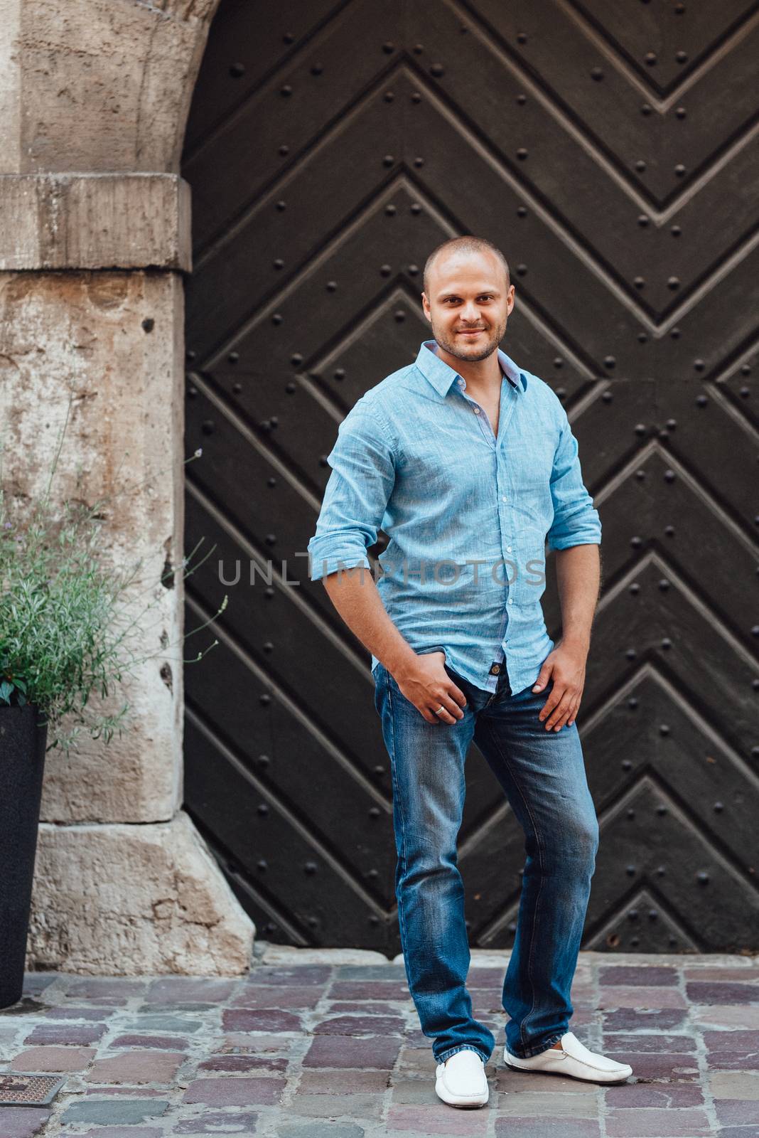 young guy, photographer walking in the old streets of europe by Andreua