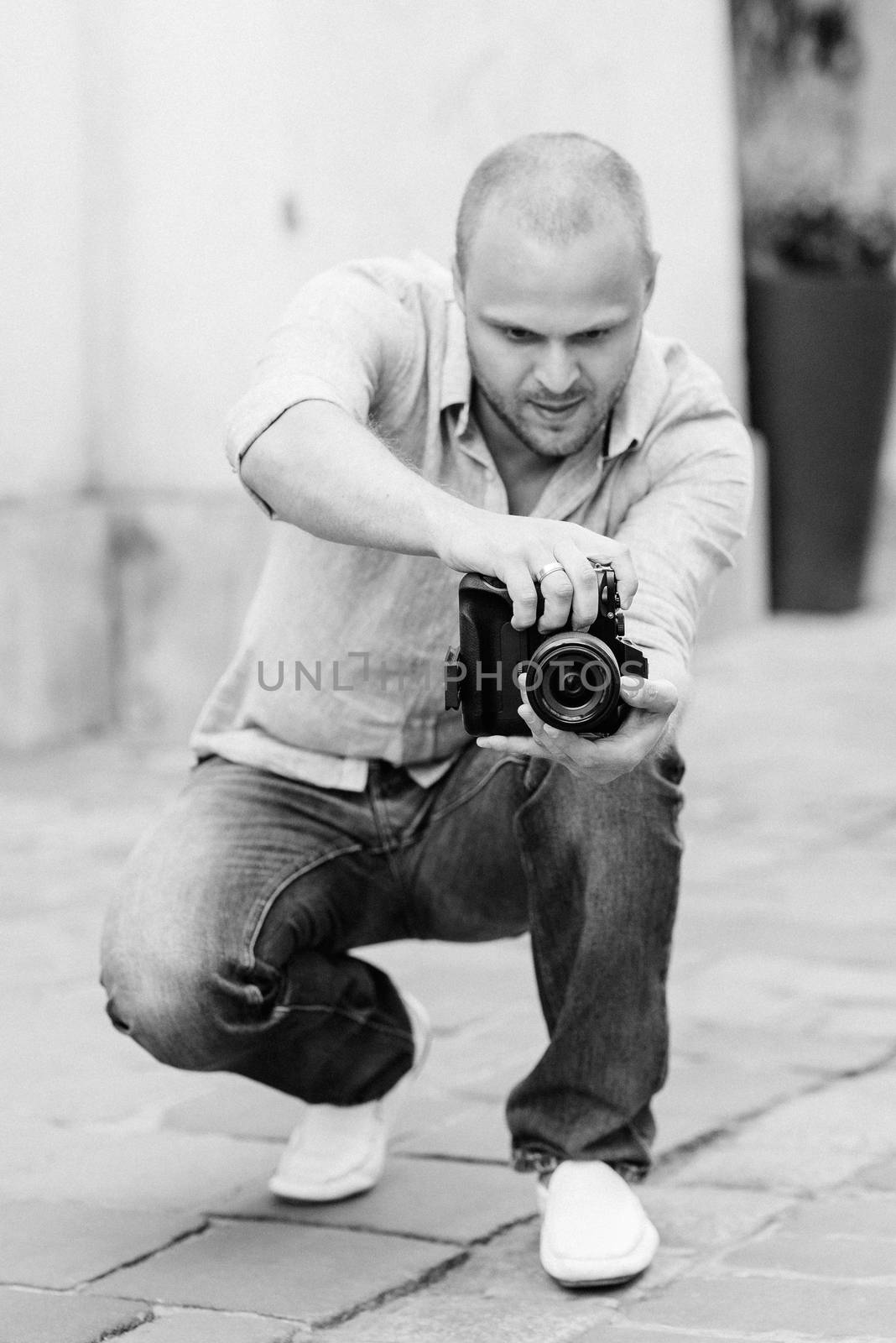 young guy, photographer walking in the old streets of europe by Andreua