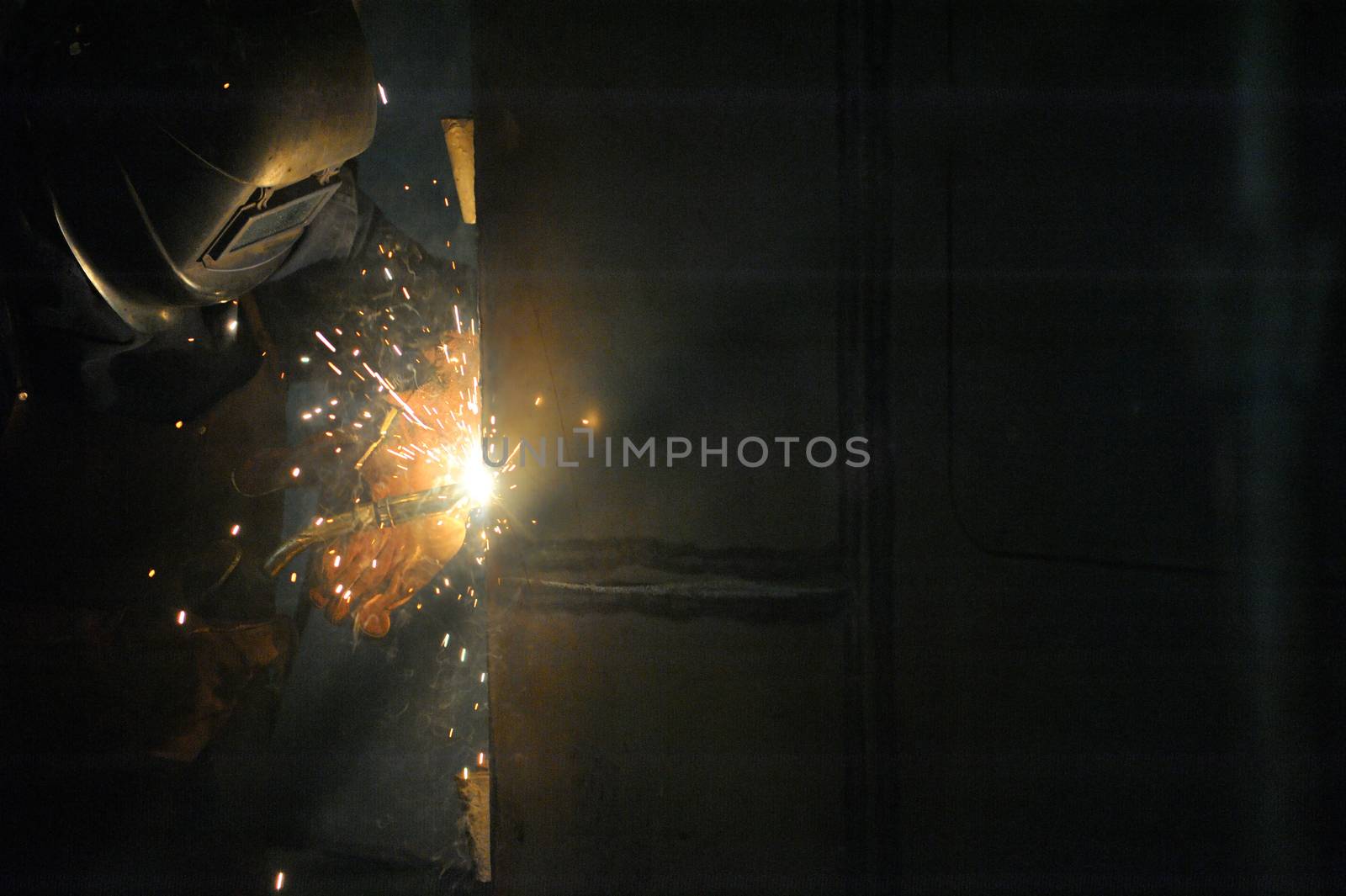 Worker With Protective Mask Welding Metal