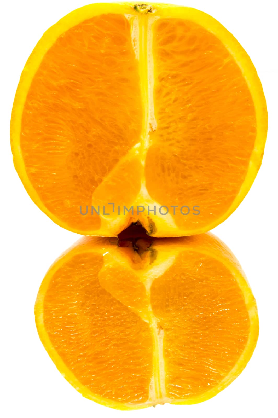 Close up on an orange half with a reflection on a white background