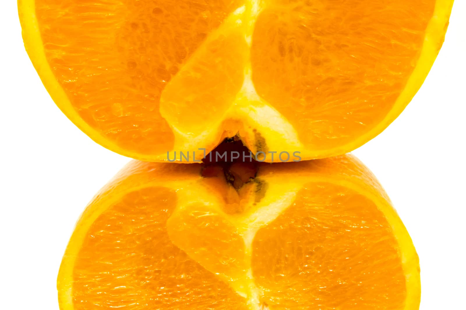 Close-up on a quarter of orange with a reflection on a white background